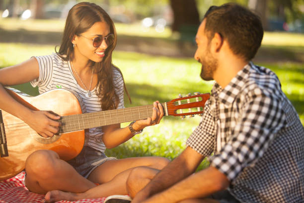 istock Man and woman having fun and playing guitar 657914040