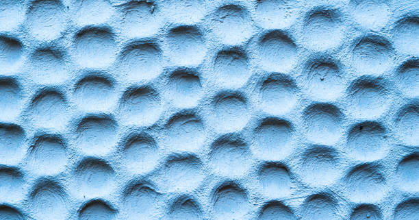 istock Texture of blue wall plastered in form of honeycombs 657914262