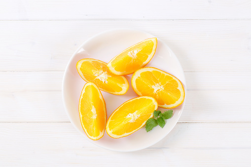 slices of fresh orange on white plate