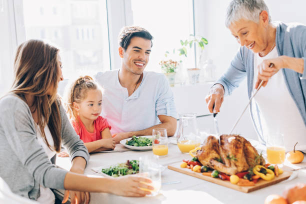 istock Grandmother is cutting the roasted turkey 657915042