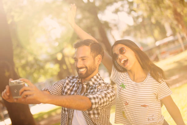 istock Man and woman taking a self portrait 657918028