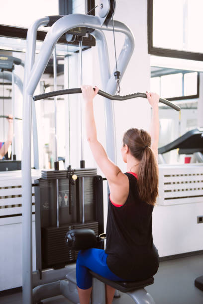 istock Young woman doing exercises on a machine at the gym 657922140