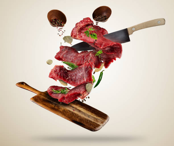 istock Flying raw steaks with ingredients, food preparation concept 657923172