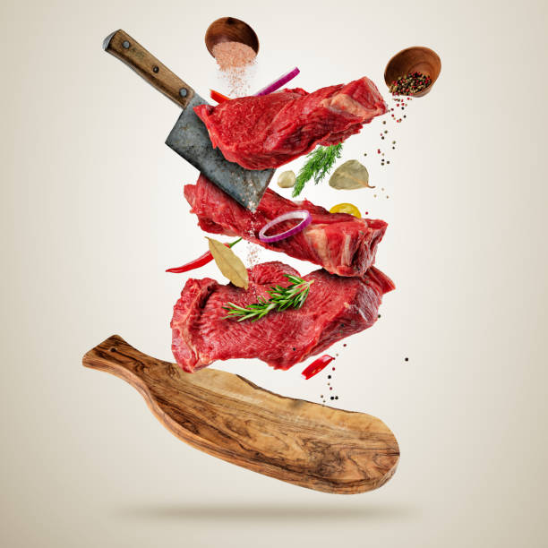 istock Flying raw steaks with ingredients, food preparation concept 657923214