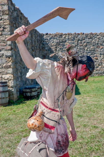 Rustic wooden stockade with metal shackles for historical medieval reenactment.