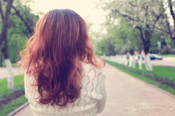istock girl walking in spring apple alley 657928466