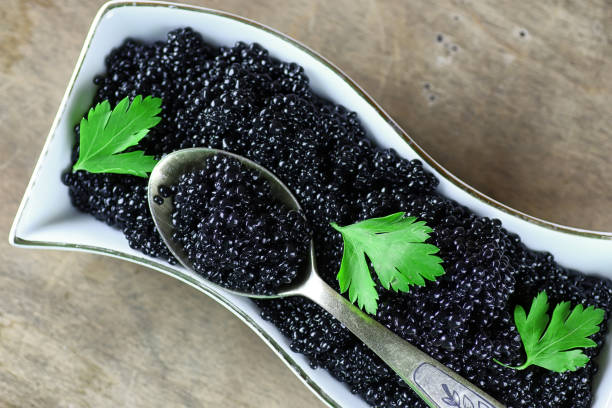 istock black caviar on a wooden background 657929996