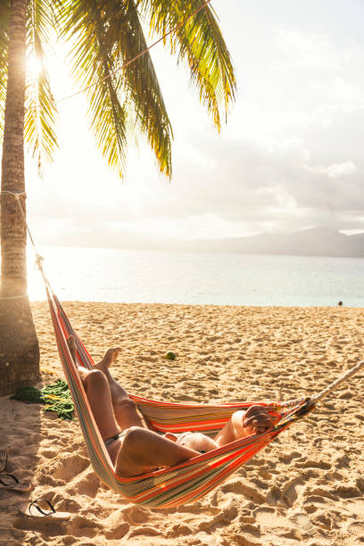 istock Senior man in hammock on the beach 657942738