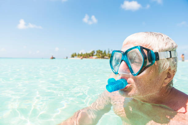 Young woman snorkelling in the crystal clear blue water , underwater view.