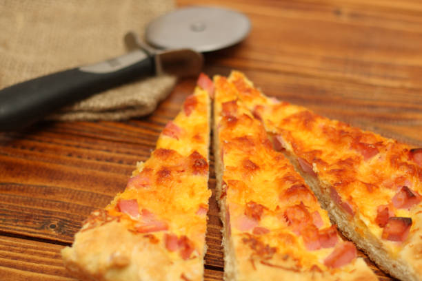istock Pizza on plate with cutter on wood table 657961962