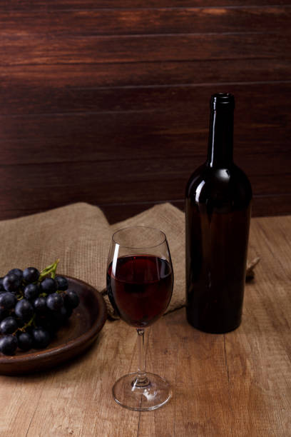 istock Red wine. Wineglass with grapes branch. 657965320