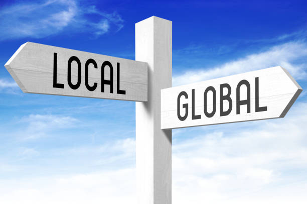 Local, global - wooden signpost stock photo