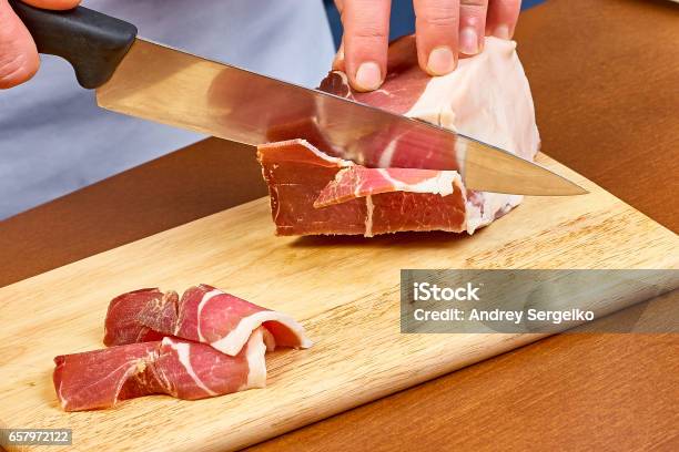 Dry Cured Ham Thinly Sliced Closeup On Chef Hands Slices Prosciutto Italian Delicatessen Stock Photo - Download Image Now