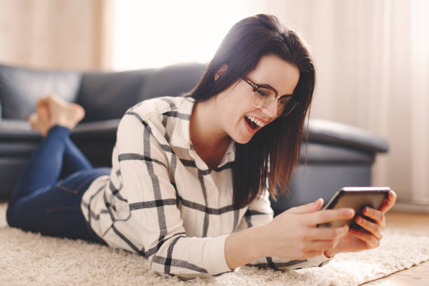istock Woman reading jokes on tablet at home 657981298