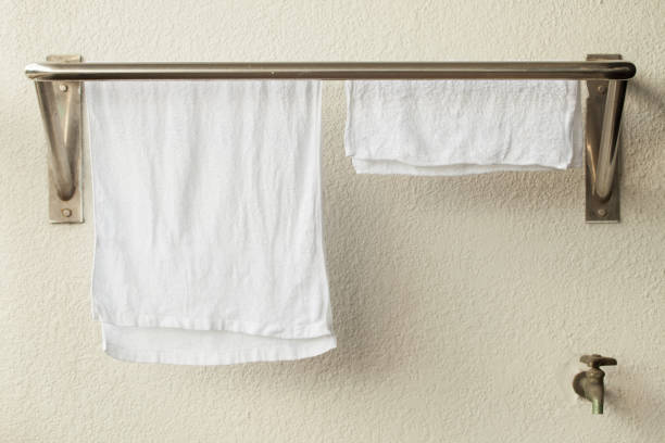 istock Stainless steel towel hanger on white cement wal 657981626