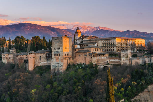Arabic palace Alhambra in Granada,Spain Arabic palace Alhambra in Granada,Spain at twilight with Sierra Nevada mountains in background granada stock pictures, royalty-free photos & images