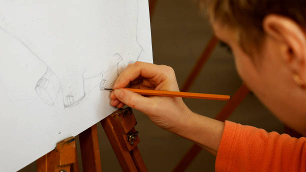 istock Female artist draws a pencil sketch in art studio 657996150
