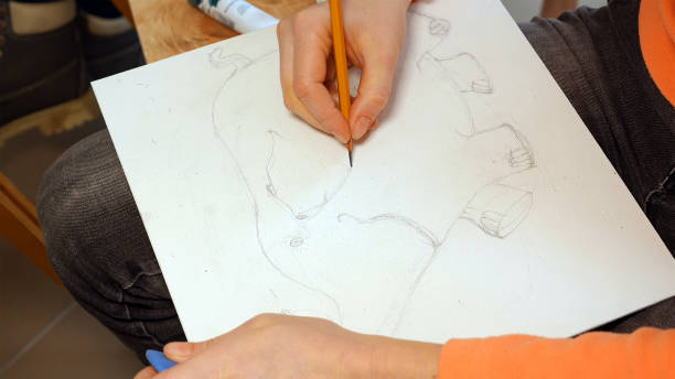 istock Female artist draws a pencil sketch in art studio 657996174