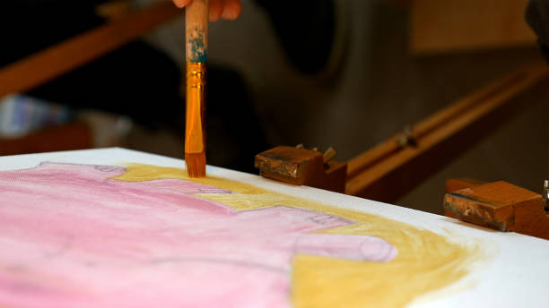 istock Artist paints picture artwork canvas in art studio 657996276
