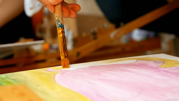 istock Artist paints picture artwork canvas in art studio 657996280