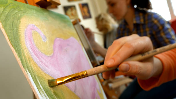 Female artist draws a pencil sketch in art studio