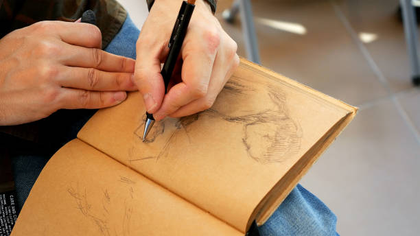 istock Graphic artist draws sketch picture artwork manual 657996410