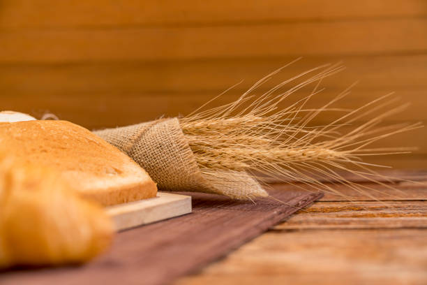 Freshly baked delicious bread on a rustic wooden background with copy space, flat lay.