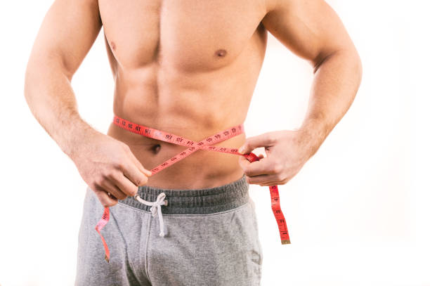 istock Male torso and red tape measure on white background 658011150