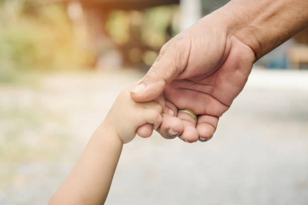 istock Father and son holding hands together. 658014434