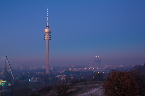 Looking at Munich Skyline from Olympiapark highpoint during twilight