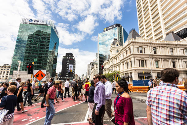 The streets of Auckland on a sunny day in New Zealand AUCKLAND, NEW ZEALAND - FEBRUARY 22, 2017: Pedestrians cross a street in the busy Auckland central business district in New Zealand largest city on a sunny day. auckland region photos stock pictures, royalty-free photos & images
