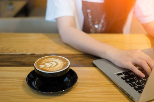 istock Woman using computer laptop in coffee shop 658035838