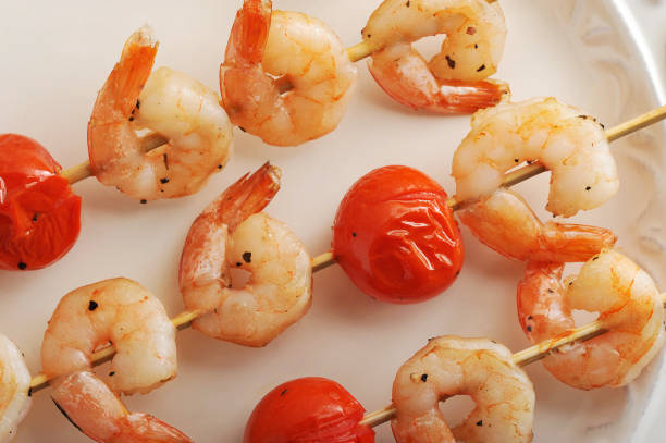 istock skewered shrimp with cherry tomatoes on wooden stick 658036484