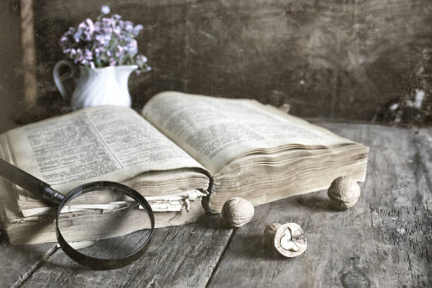 istock old scratched effect on photo magnifying glass and old book 658042454