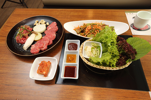 Korea Food in Restaurant on wooden table, set of beef pork unyank gwangyang assorted slice brisket grilled pork belly marinated neck meat