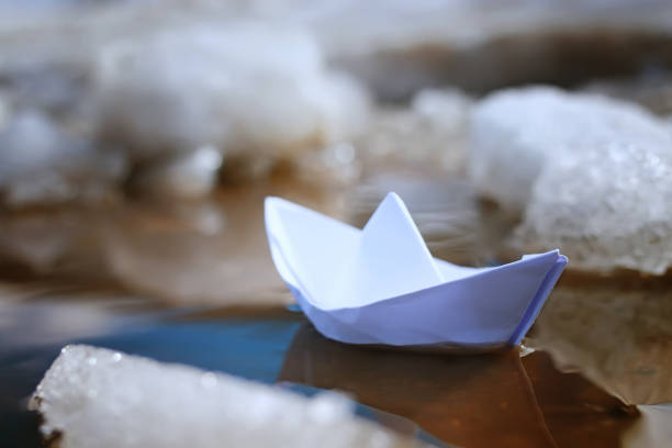 istock tinted photo paper boat on spring street 658050938