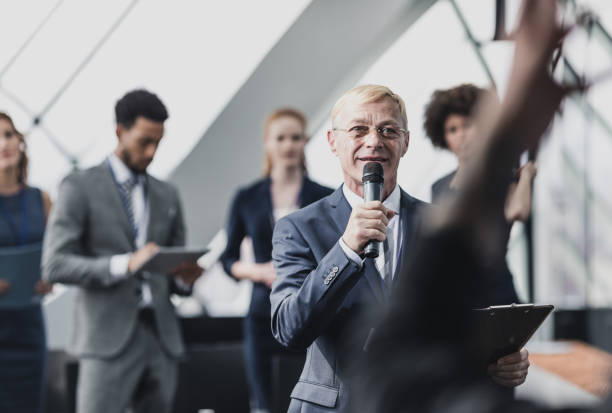istock Group of Business People on a Conference Event Asking Questions 658051874