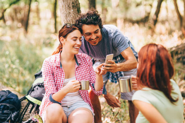 istock Hikers surfing the net in the woods 658052282