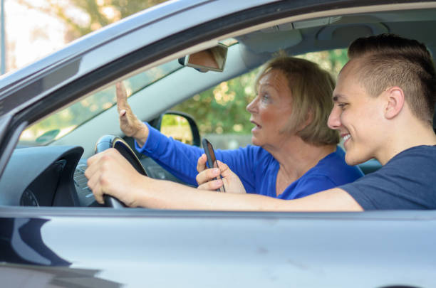 istock Young man texting at the wheel of a car 658054562