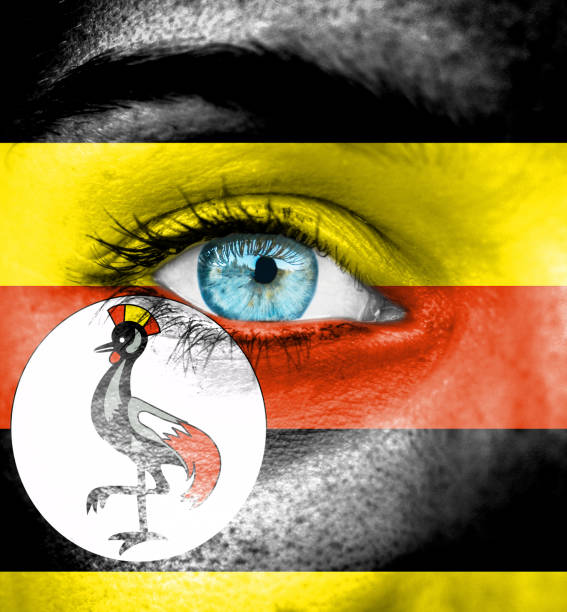 istock Woman face painted with flag of Uganda 658058890