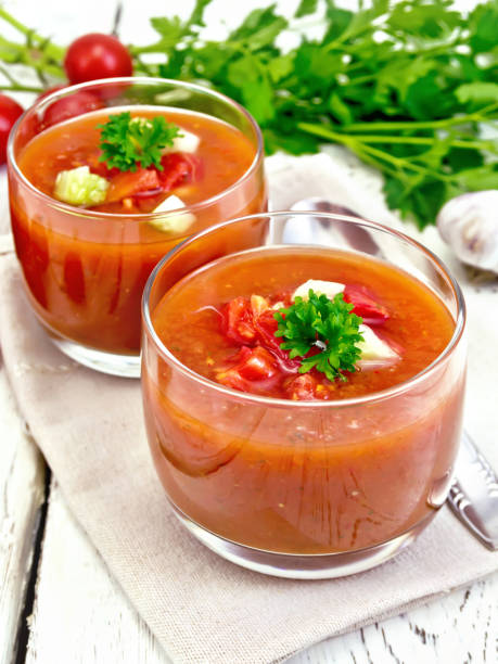 istock Soup tomato in two glasses with parsley on napkin 658065512