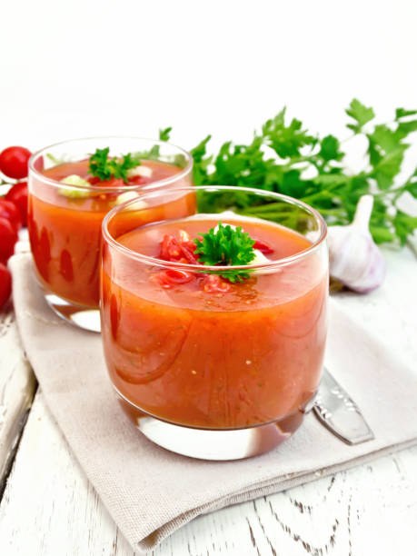 istock Soup tomato in two glasses with parsley on board 658065524