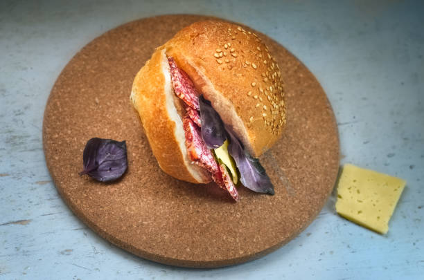 istock Sandwich with smoked sausage, cheese and basil 658068512