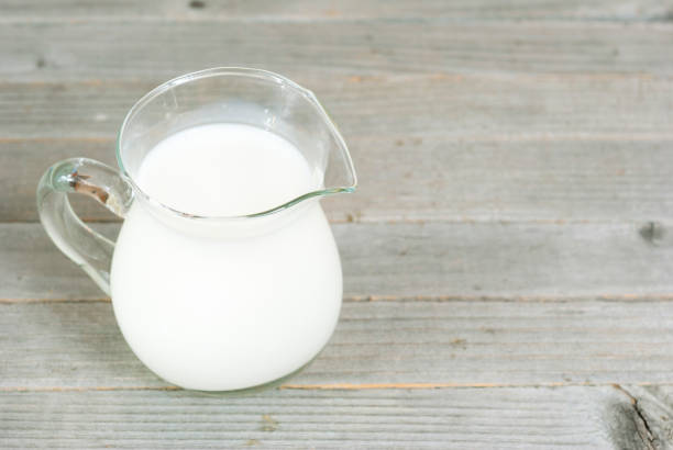 istock Milk jug on weathered wood 658072546
