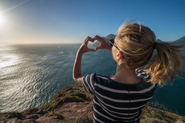 istock Young woman loving nature, heart shape frame 658074850