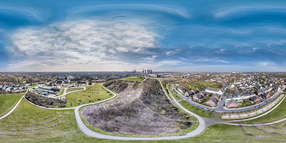 DUISBURG / GERMANY - MARCH 24 2017 : Landmark Tiger and Turtle standing on a hill while HKM is producing steel in the background, aerial