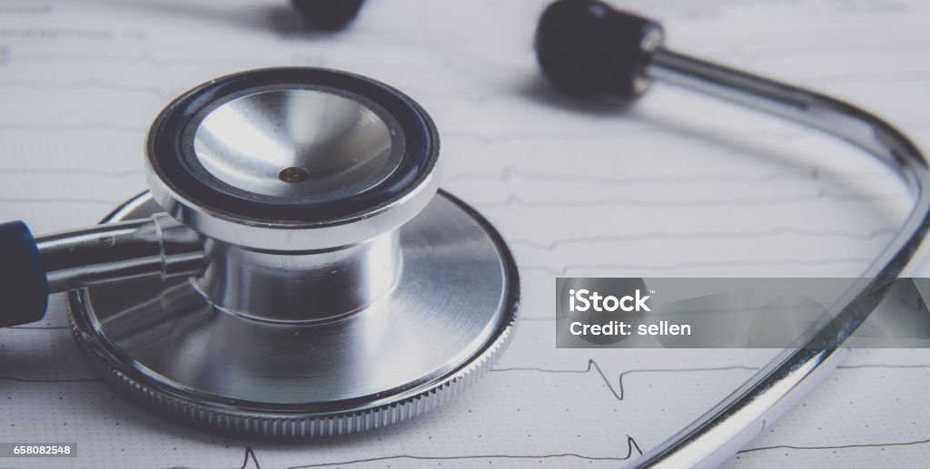 Stethoscope on electrocardiogram lying at the desk Stethoscope on electrocardiogram lying at the desk. Belarus Stock Photo