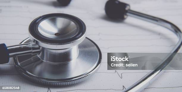 Stethoscope On Electrocardiogram Lying At The Desk Stock Photo - Download Image Now - Belarus, Cardiologist, Electrocardiography