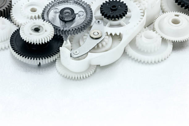 istock white and black plastic gears on scratched metal background 658085574