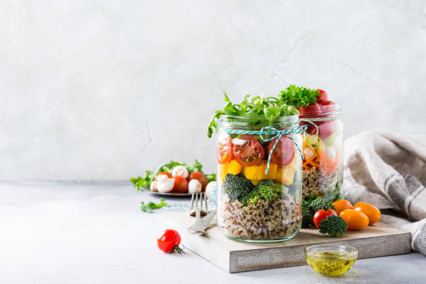 Salad in glass jar with quinoa Homemade salad in glass jar with quinoa and vegetables. Healthy food, diet, detox, clean eating and vegetarian concept with copy space. arugula photos stock pictures, royalty-free photos & images